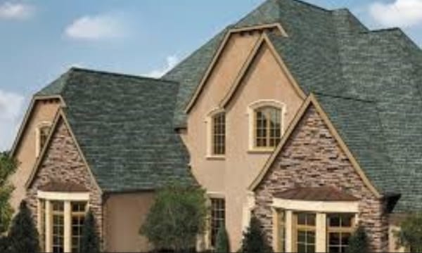 A large house with a lot of windows and a roof.